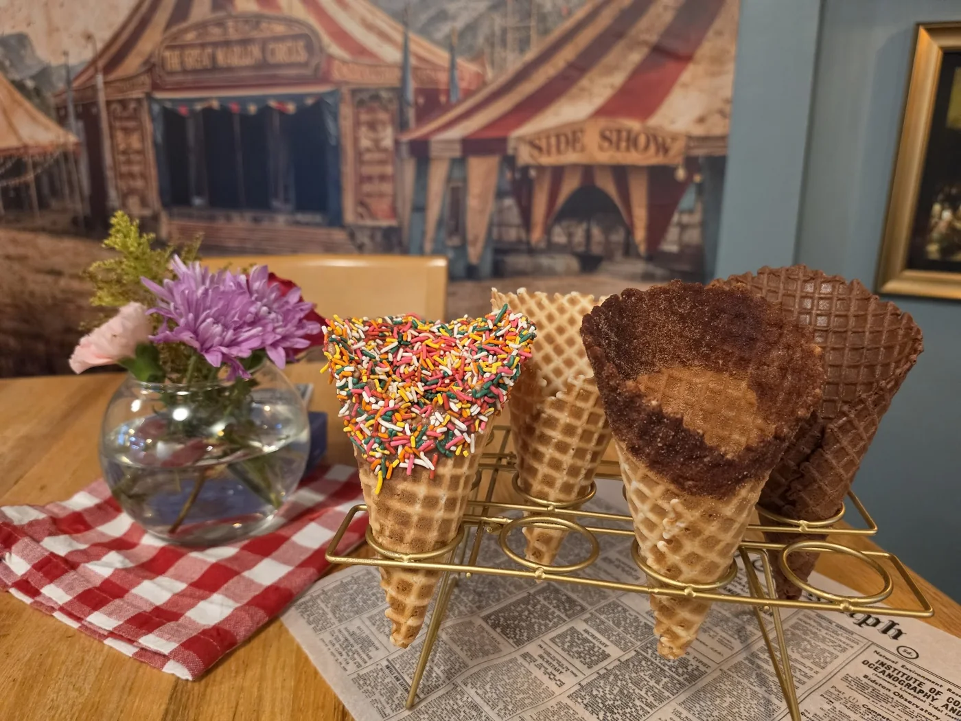 Decorated waffle cones displayed inside Alpenglow Treat Co